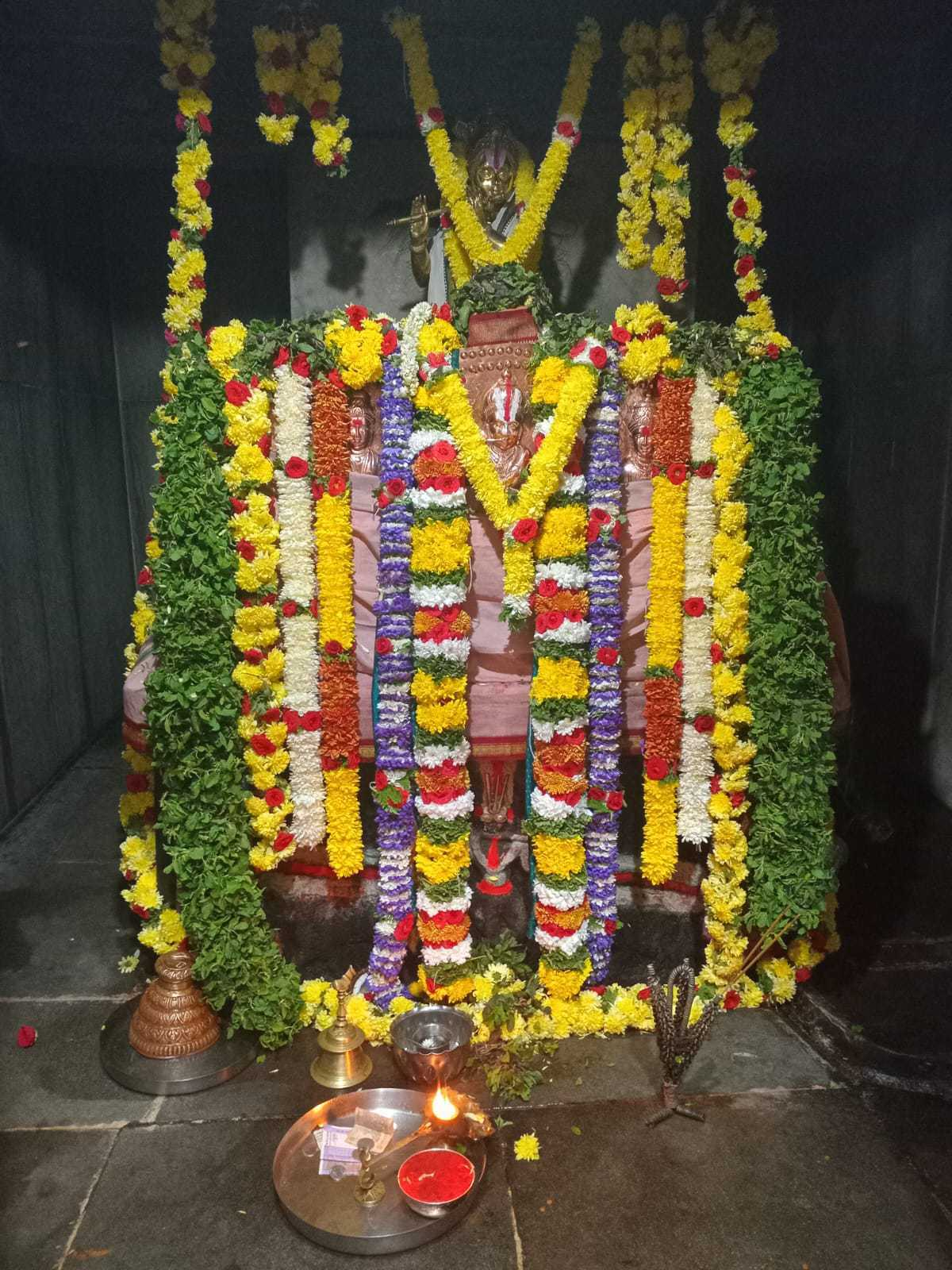 Temple shrine prepared with flower garlands and lamps